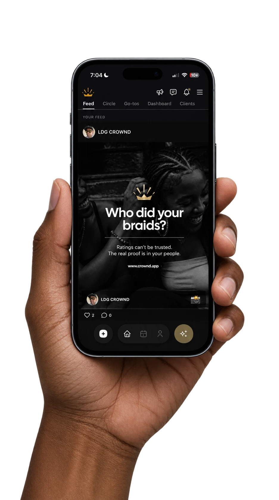 A social app's feed open on an iPhone, held in a hand